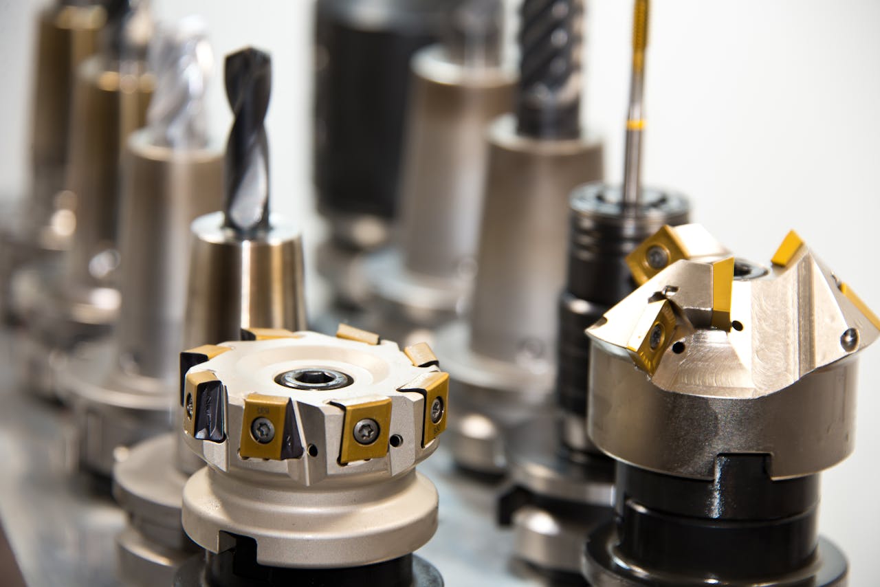 Services Detailed view of various metal drill bits and tools arranged in a workshop setting.