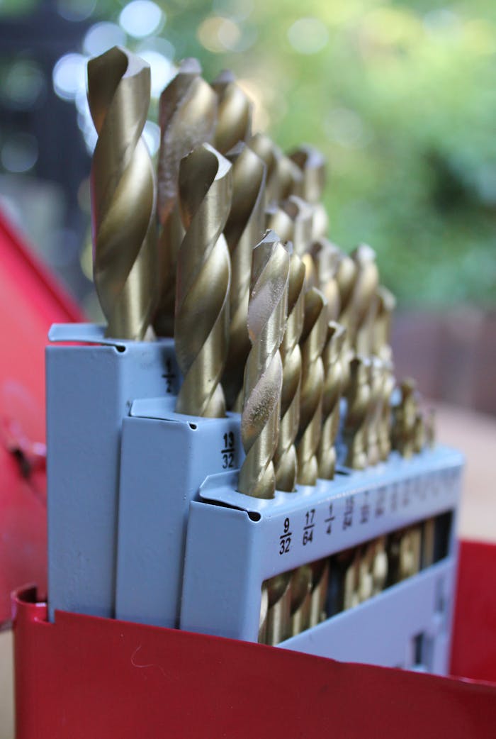 Services High-quality drill bits in a red toolbox, ideal for construction projects.
